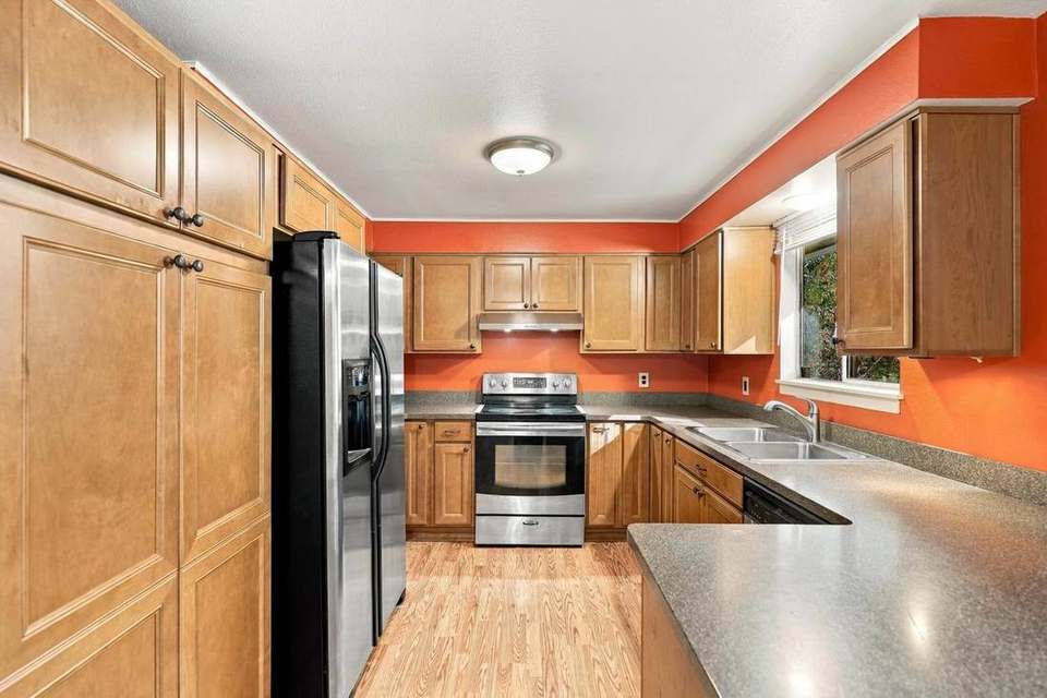 Rebuilt kitchen with wood cabinets and stainless appliances