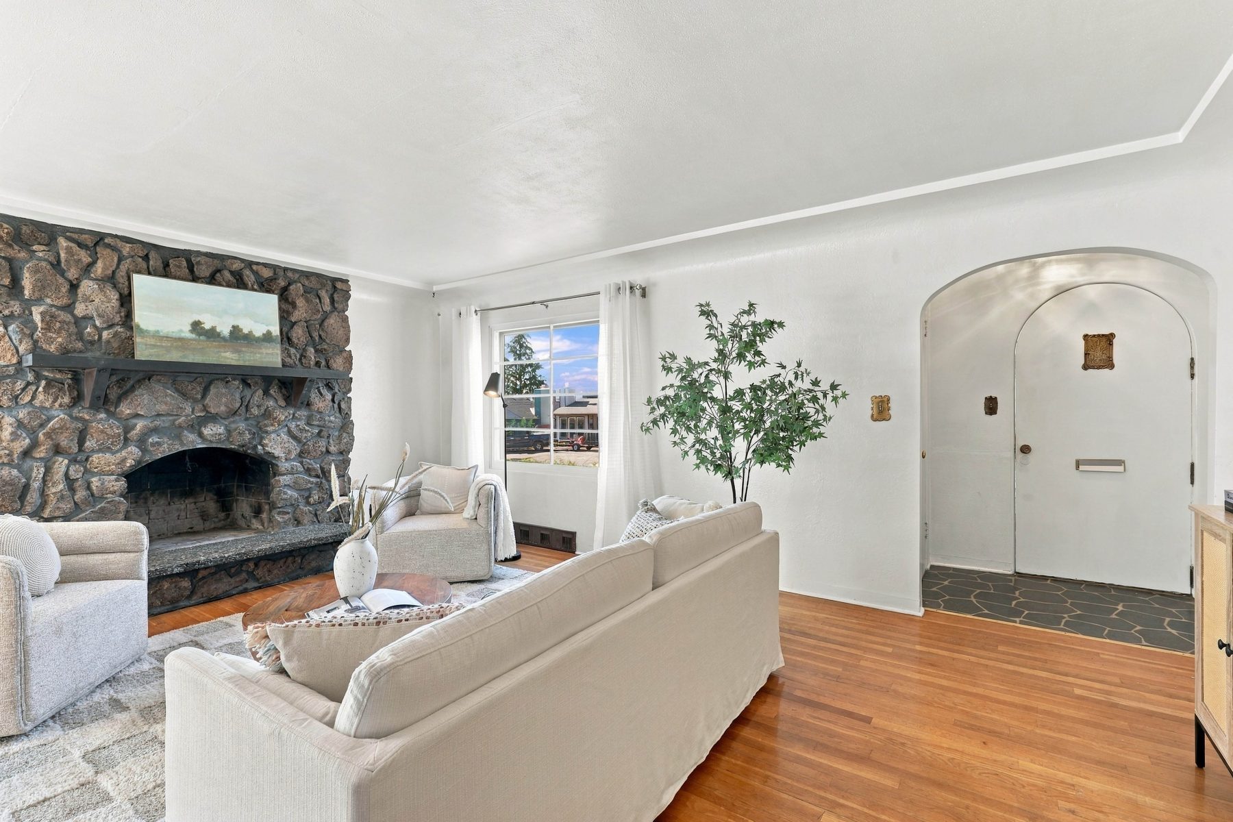 Living room with real hardwood floors and river rock fireplace