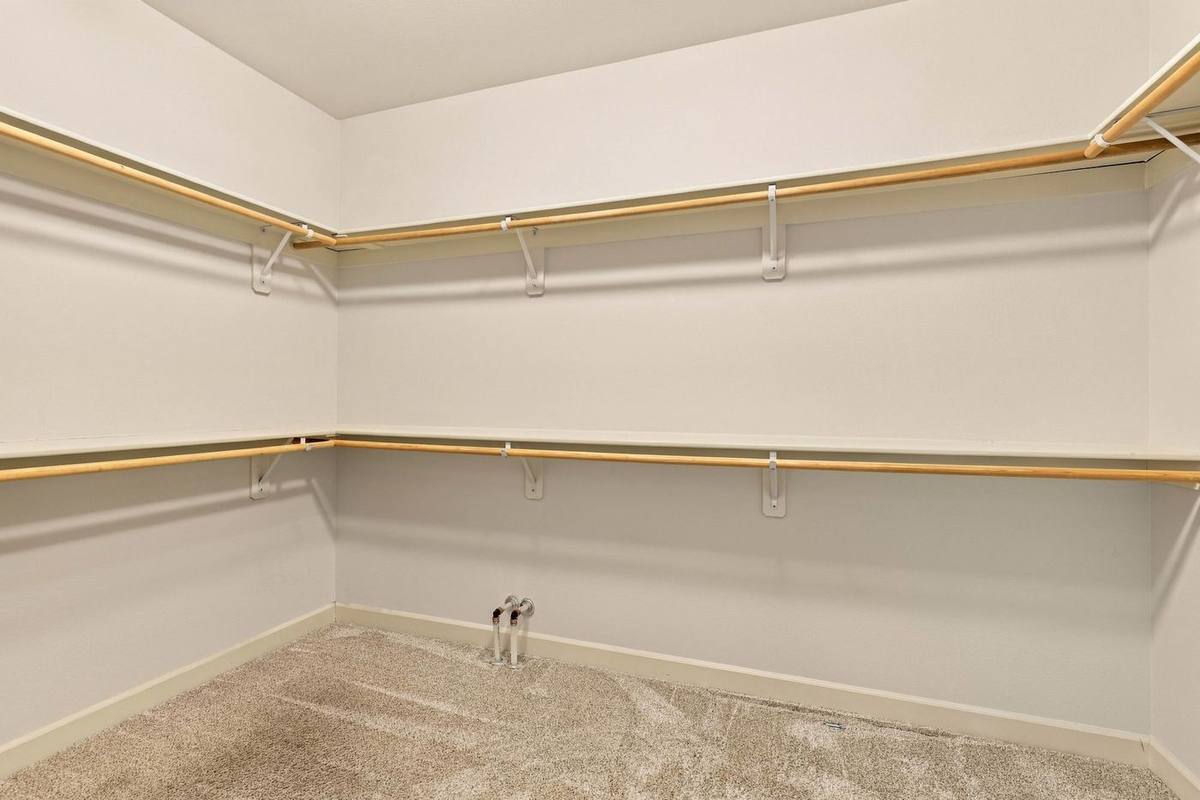 Oversized walk-in closet with wood shelving