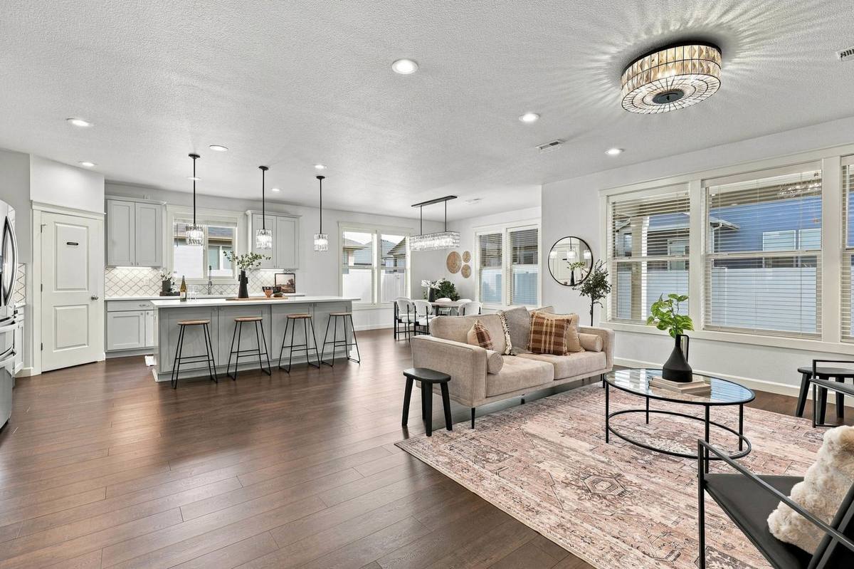 Open great room with sectional seating and kitchen beyond